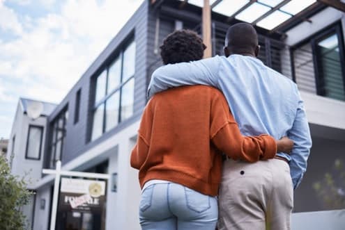 Self-employed individuals looking over their new house
